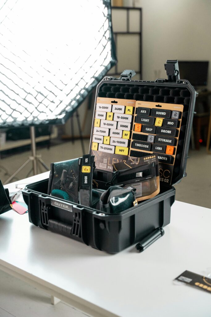 Organized camera accessories in a case during studio setup.